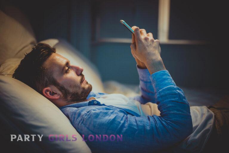 Man using his phone at home in a quiet, private setting before making a booking
