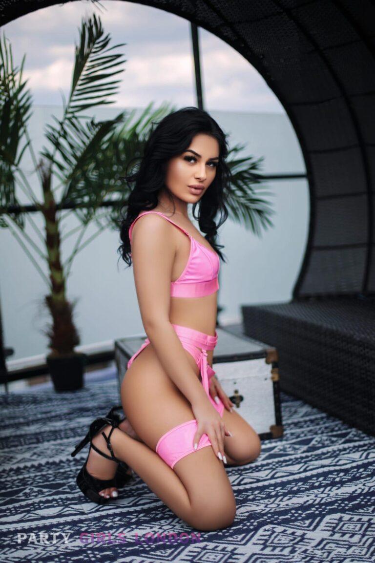 Ella – Brunette Escort in Earls Court Kneeling Sweetly in Pink