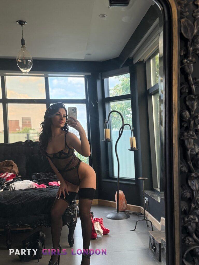Escort girl London showing off her curves in black lingerie